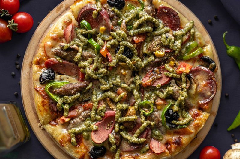 Pizza sauce in pan with herbs